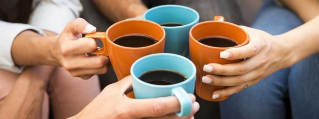 Four people sharing coffee together.