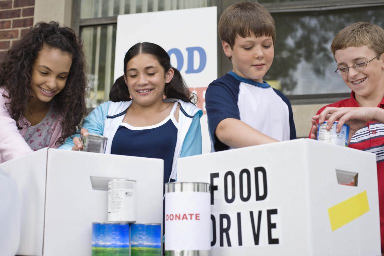 Kids supporting a food drive table